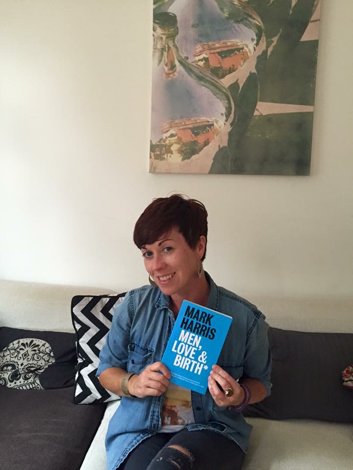 A reader holding Men, Love & Birth